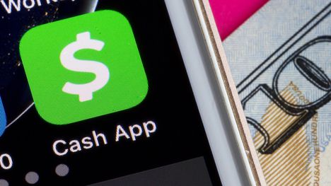 CASH app on Smartphone next to $100 dollar bill (Shutterstock)
